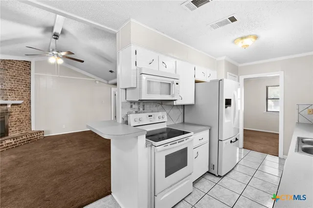 a kitchen with stainless steel appliances granite countertop a stove and a refrigerator