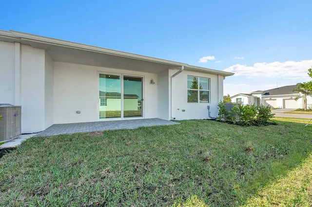 a view of an house with backyard space and garden