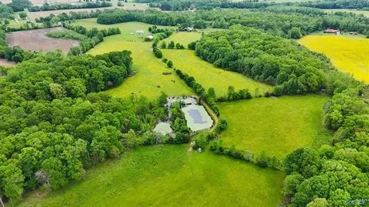 an aerial view of residential houses with outdoor space and swimming pool