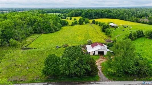 an aerial view of a house with yard