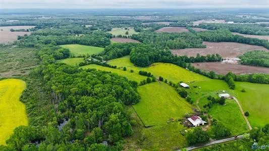 an aerial view of a residential houses with outdoor space and garden