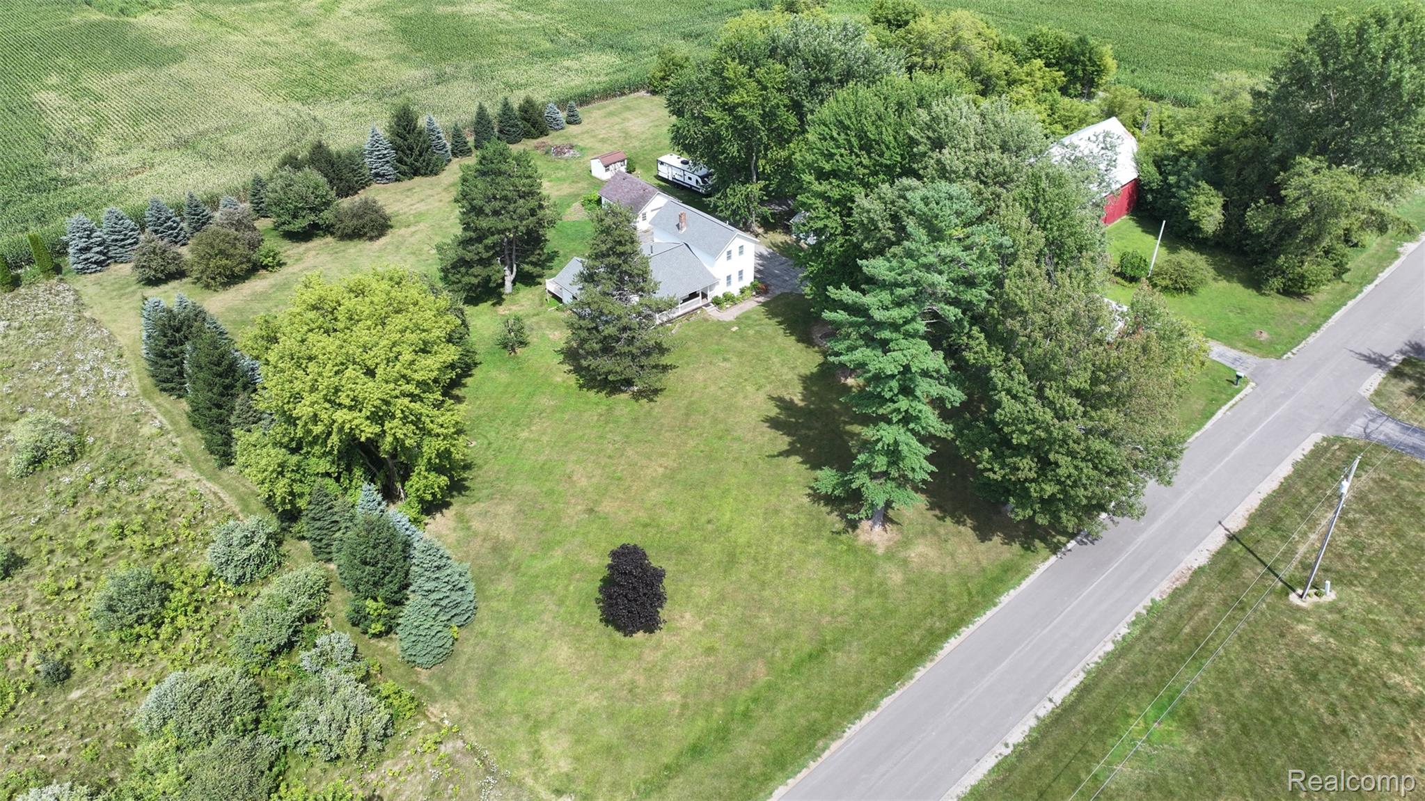 12930 Wilkinson Road Freeland, MI 48623 - Photo 27 of 76 Expansive property featuring a main residence, an outbuilding, and mature trees