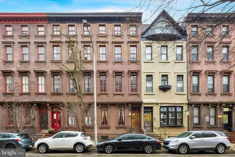 a couple of cars parked in front of a building