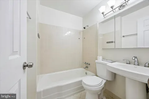 a bathroom with a sink a toilet and a bathtub