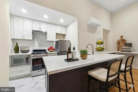 a kitchen with a table chairs stove and cabinets