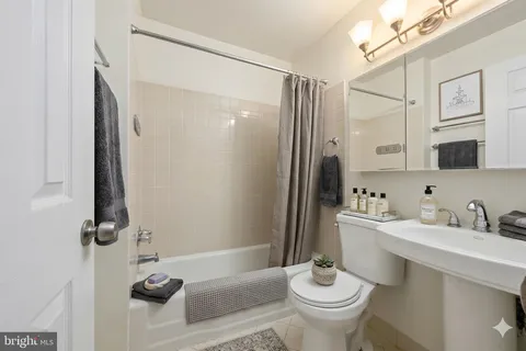 a bathroom with a sink toilet a mirror and shower
