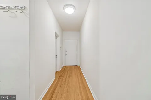 a view of a hallway with wooden floor