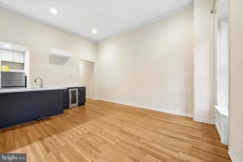 a view of a room with wooden floor and cabinet