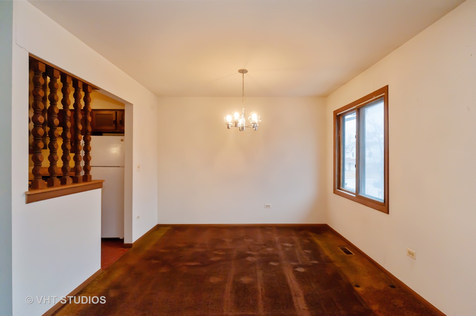 1485 Chippewa Trail Wheeling, IL 60090 - Photo 6 of 20 a view of an empty room with window and wooden floor