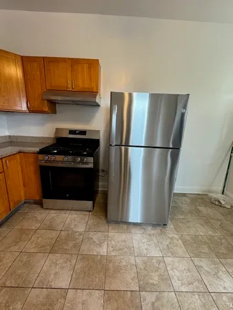 a kitchen with a stove a refrigerator and a cabinets