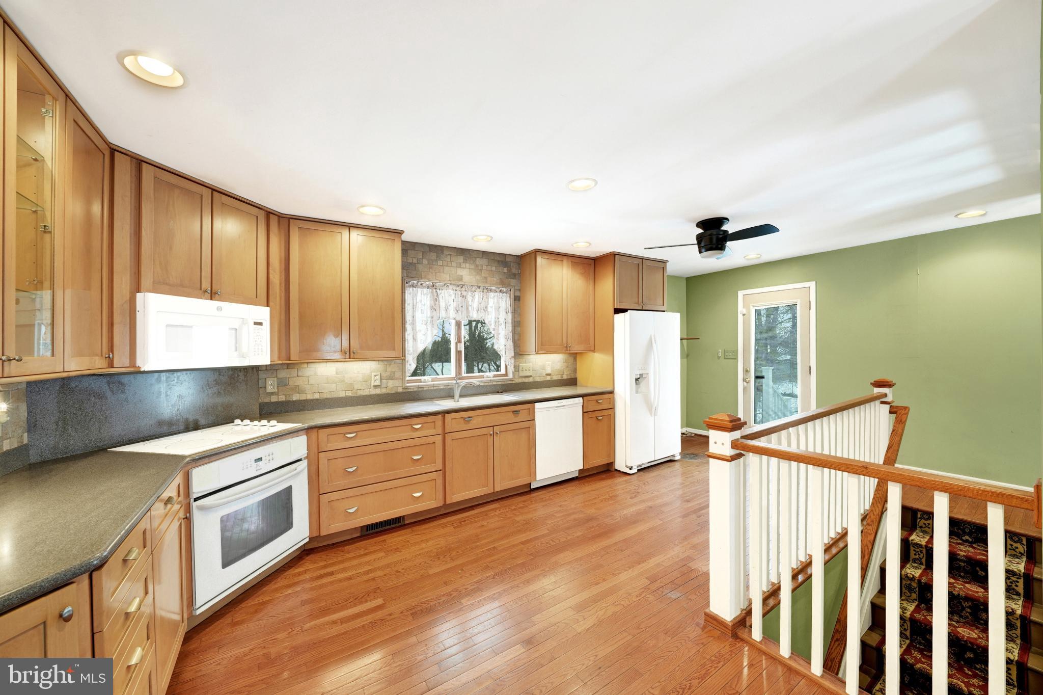 335 East Village Road Elkton, MD 21921 - Photo 21 of 29 a kitchen with granite countertop a stove a sink and a refrigerator