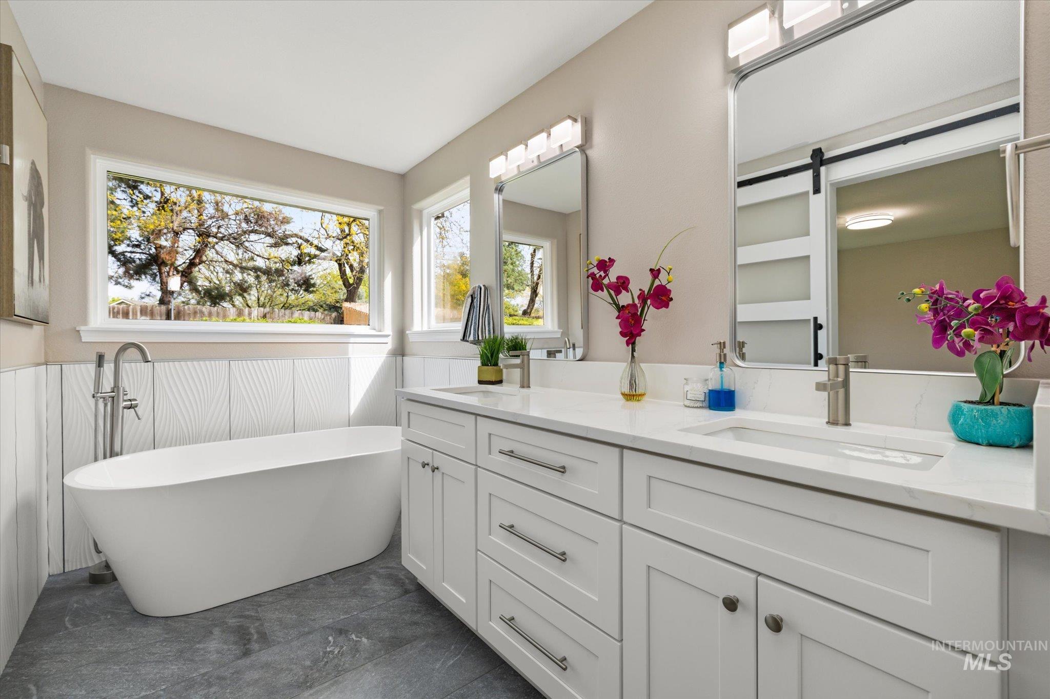2250 North Amethyst Avenue Meridian, ID 83646 - Photo 31 of 50 Bathroom featuring double vanity, wainscoting, and a freestanding tub