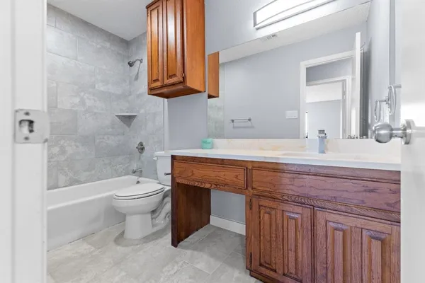 a bathroom with a sink a toilet and bathtub