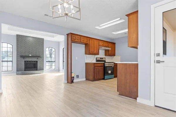 a kitchen with stainless steel appliances granite countertop a refrigerator and a stove top oven