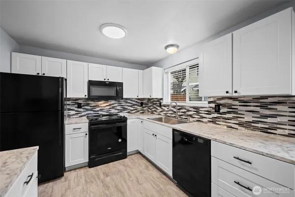 a kitchen with a stove and a refrigerator
