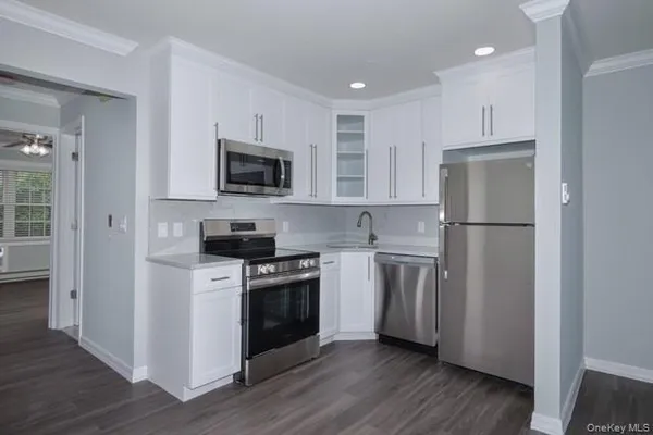 a kitchen with a refrigerator stove and microwave