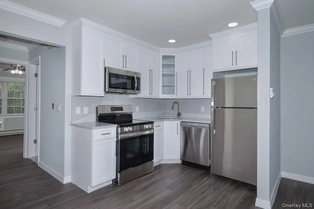 a kitchen with a refrigerator stove and microwave