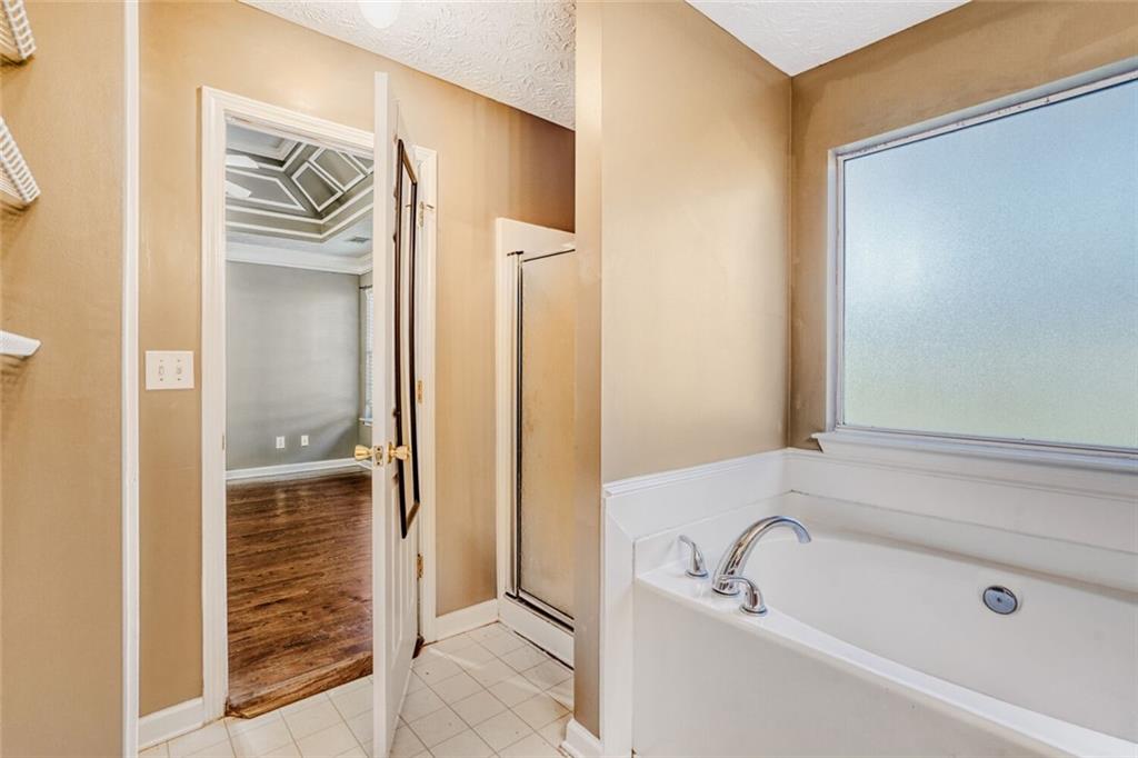 1298 Sierra Ridge Place Southeast Loganville, GA 30052 - Photo 19 of 29 a bathroom with a bathtub