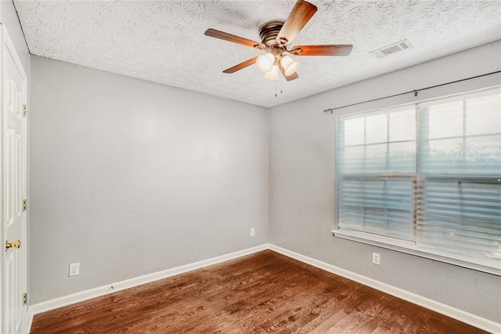 1298 Sierra Ridge Place Southeast Loganville, GA 30052 - Photo 21 of 29 an empty room with a window and a ceiling fan