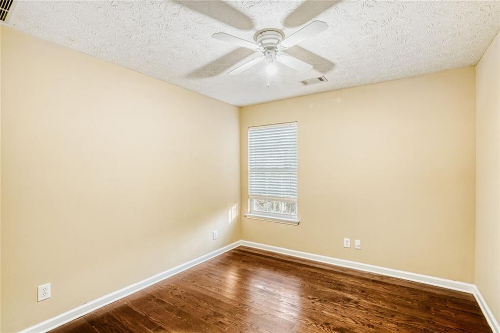 1298 Sierra Ridge Place Southeast Loganville, GA 30052 - Photo 22 of 29 an empty room with windows and fan