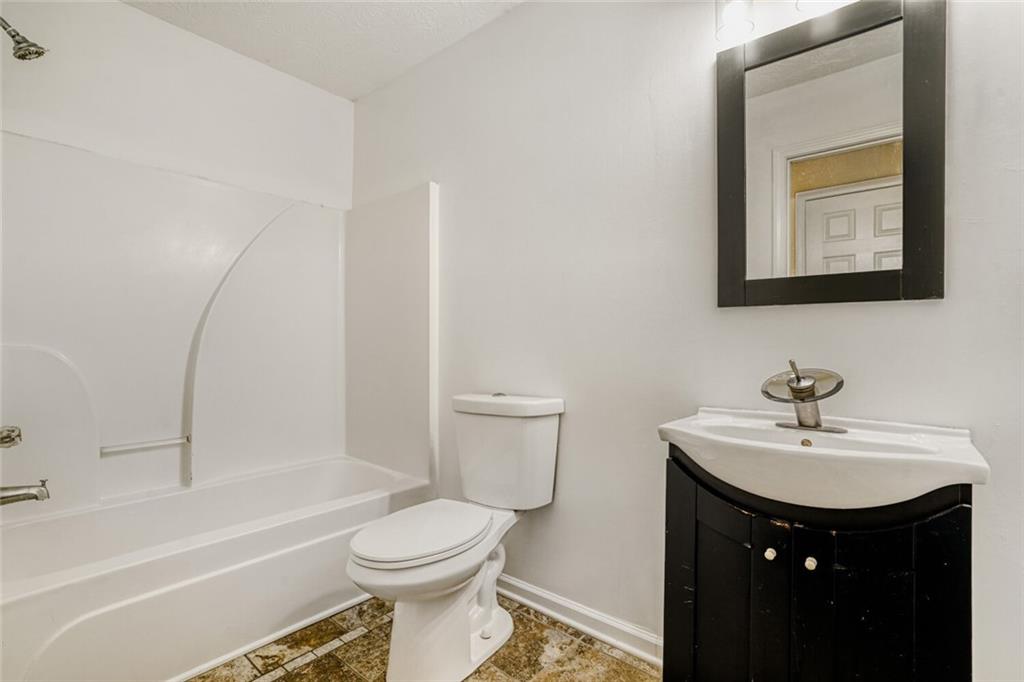 1298 Sierra Ridge Place Southeast Loganville, GA 30052 - Photo 23 of 29 a bathroom with a sink toilet and a bathtub