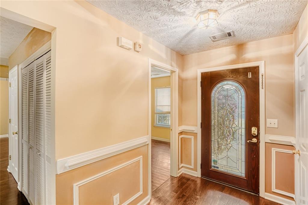 1298 Sierra Ridge Place Southeast Loganville, GA 30052 - Photo 5 of 29 a view of a entryway door with wooden floor
