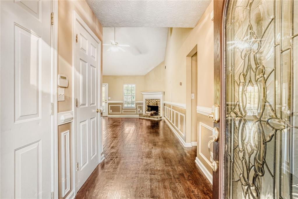 1298 Sierra Ridge Place Southeast Loganville, GA 30052 - Photo 6 of 29 a view of a hallway view with the view of living room kitchen and a wooden floor