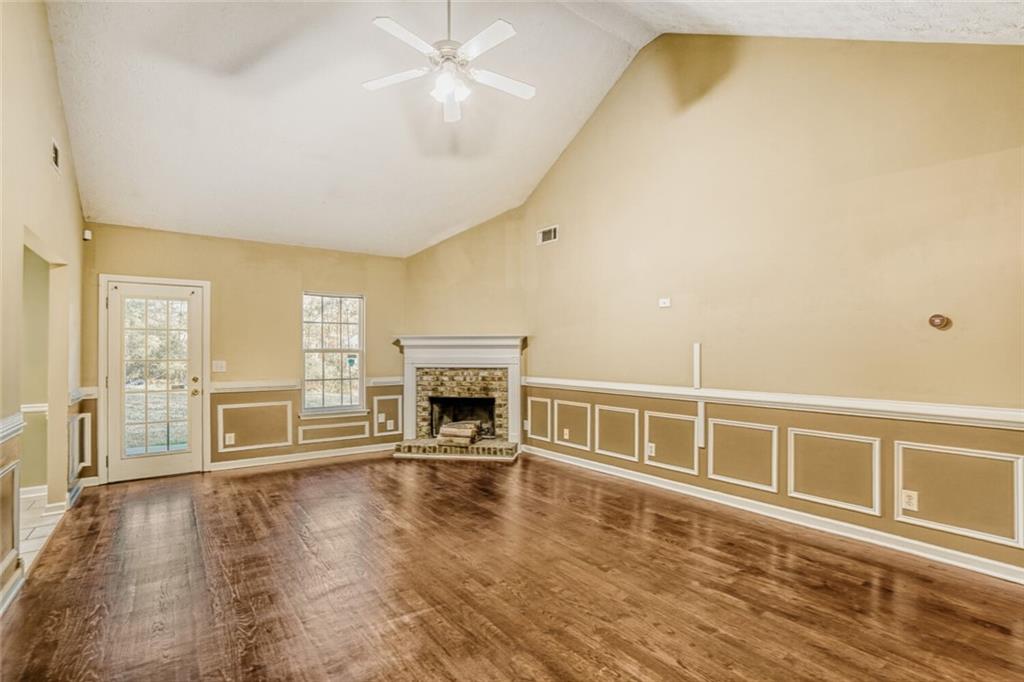 1298 Sierra Ridge Place Southeast Loganville, GA 30052 - Photo 9 of 29 a view of an empty room with a fireplace and a window