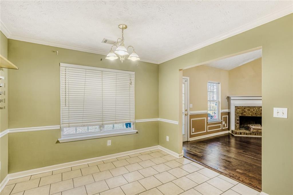 1298 Sierra Ridge Place Southeast Loganville, GA 30052 - Photo 10 of 29 a view of a livingroom with a fireplace wooden floor and chandelier