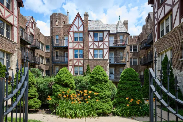 a view of a brick house next to a yard