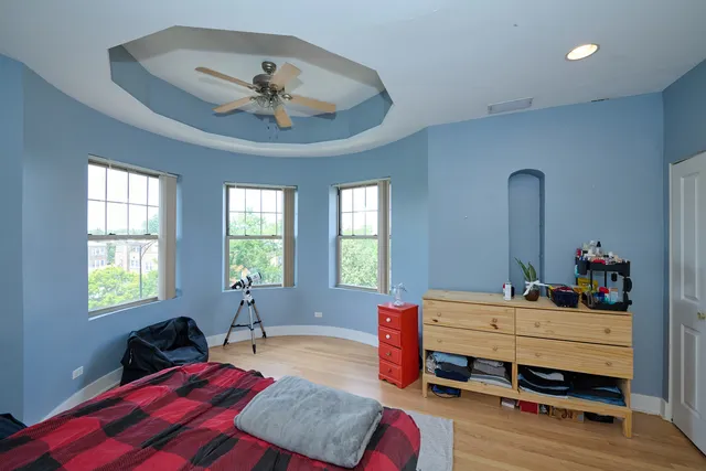 a bedroom with a bed and a chandelier