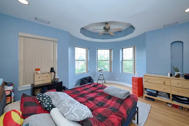 a bedroom with a bed and a large mirror