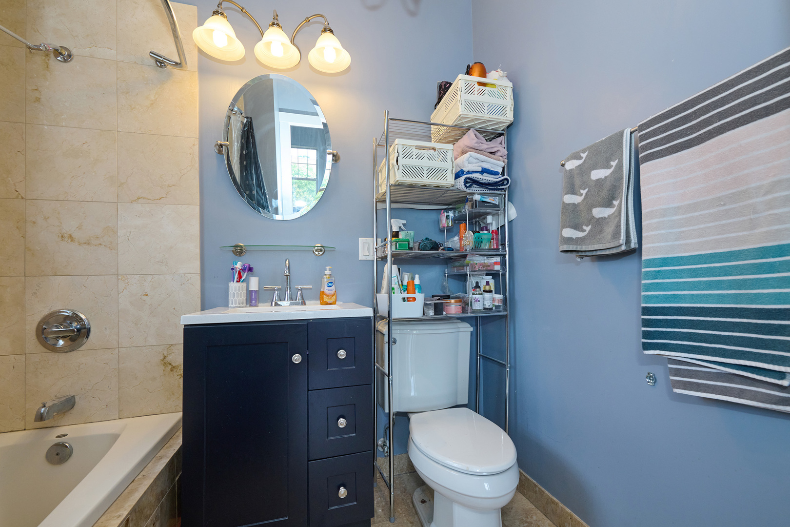 5711 North Kimball Avenue, Unit 3N Chicago, IL 60659 - Photo 18 of 24 a bathroom with a sink a toilet and a mirror