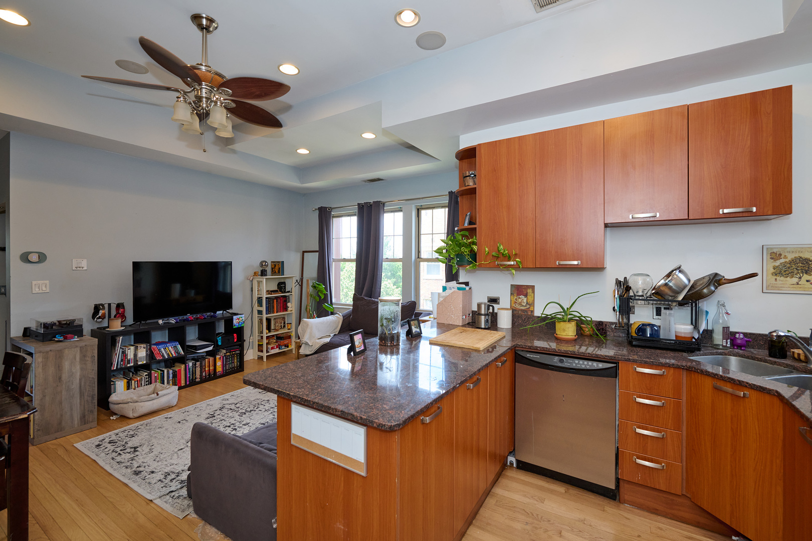 5711 North Kimball Avenue, Unit 3N Chicago, IL 60659 - Photo 2 of 24 a kitchen with stainless steel appliances granite countertop a sink dishwasher stove and refrigerator with wooden cabinets