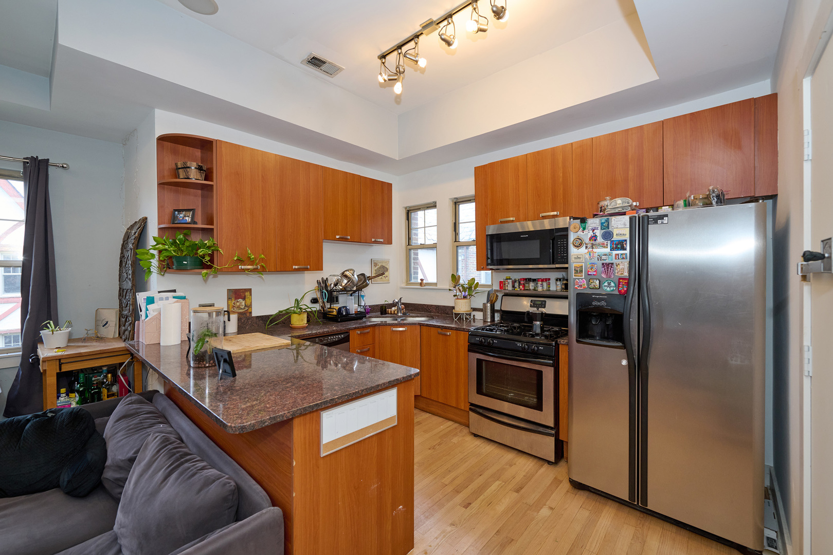 5711 North Kimball Avenue, Unit 3N Chicago, IL 60659 - Photo 3 of 24 a kitchen with stainless steel appliances granite countertop a sink a stove and a refrigerator