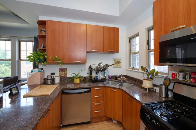 a kitchen with a sink stove top oven and microwave