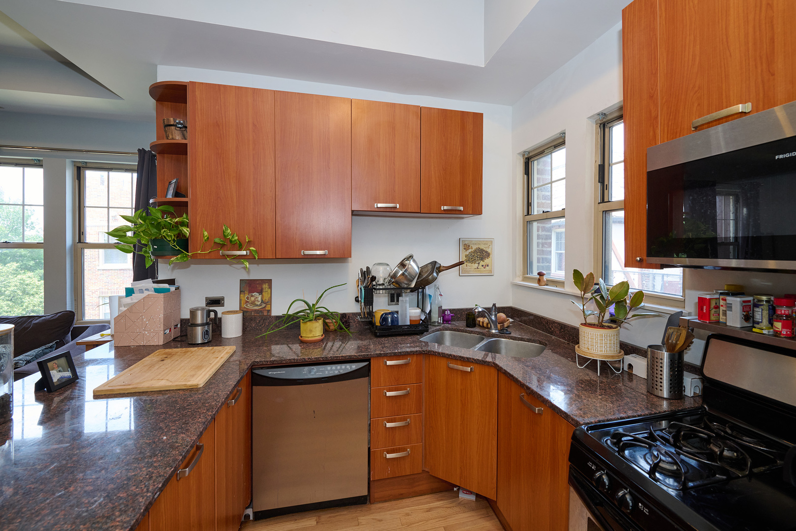 5711 North Kimball Avenue, Unit 3N Chicago, IL 60659 - Photo 6 of 24 a kitchen with a sink stove top oven and microwave