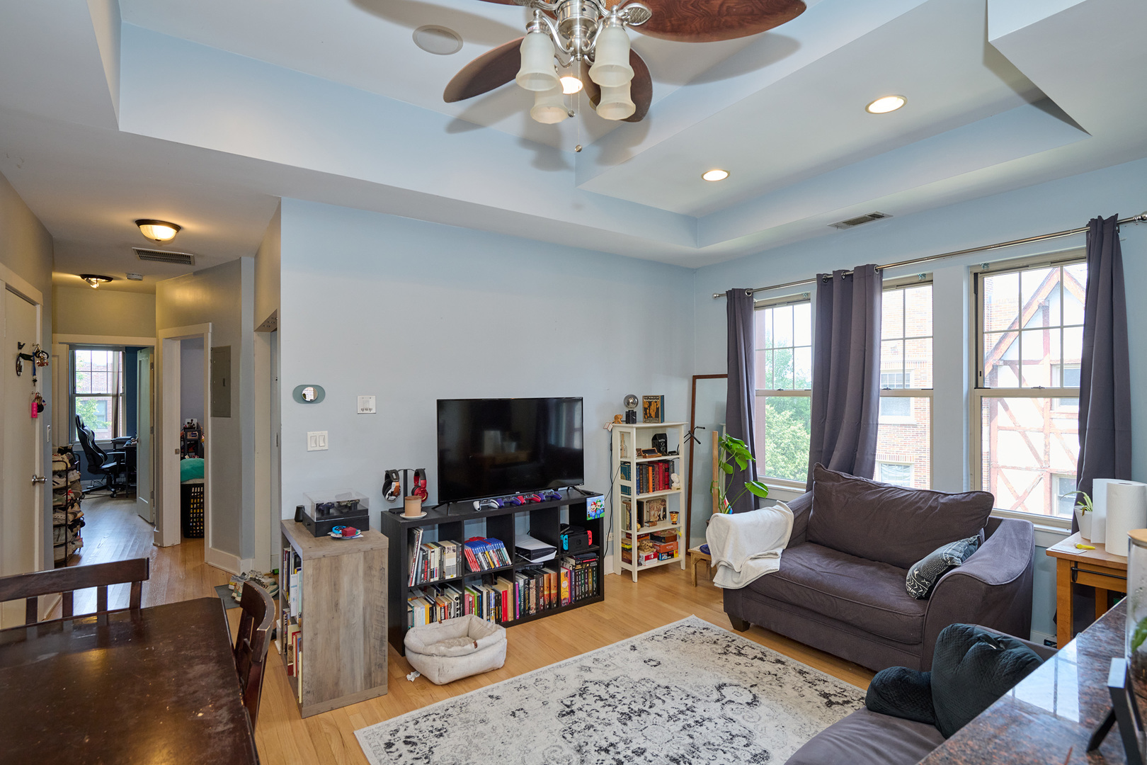 5711 North Kimball Avenue, Unit 3N Chicago, IL 60659 - Photo 8 of 24 a living room with furniture and a flat screen tv
