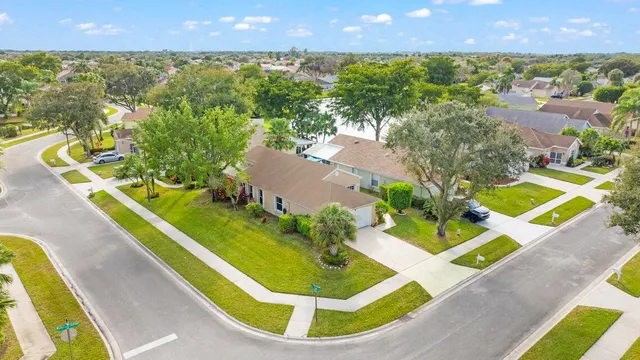 a view of a swimming pool with a patio and a yard