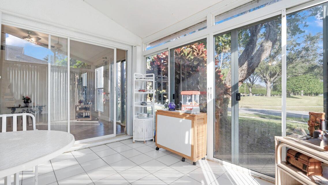 7961 Mansfield Hollow Road Delray Beach, FL 33446 - Photo 13 of 19 a room with a large window and furniture