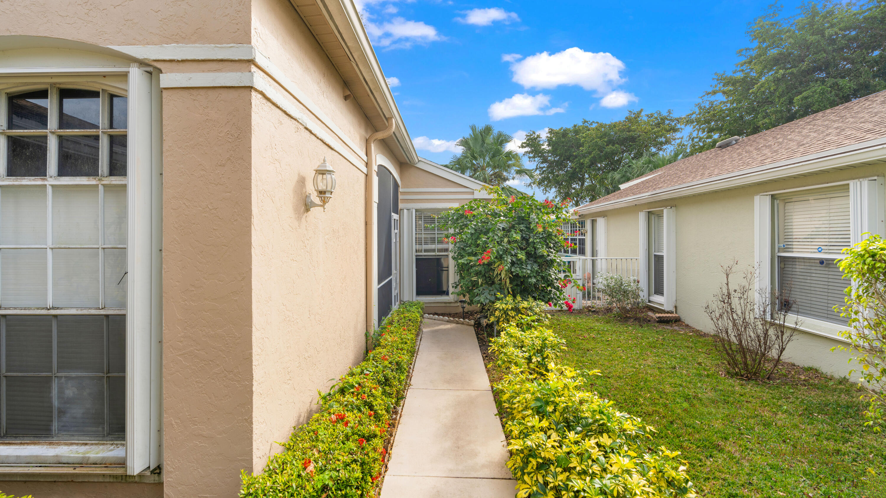 7961 Mansfield Hollow Road Delray Beach, FL 33446 - Photo 14 of 19 a view of a pathway with house on the background
