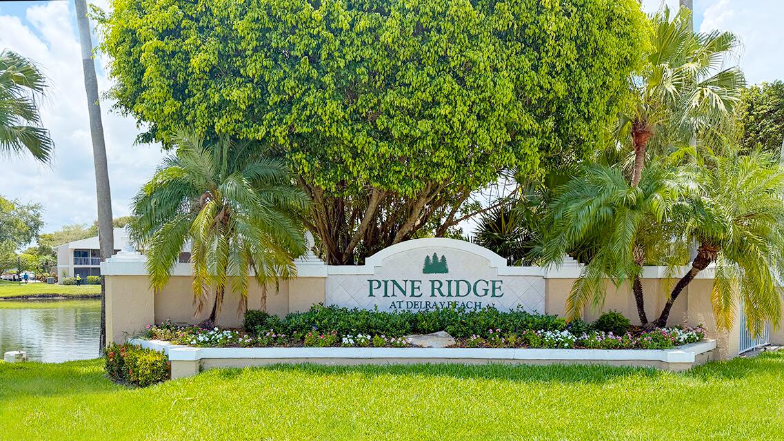 7961 Mansfield Hollow Road Delray Beach, FL 33446 - Photo 2 of 19 a view of a water fountain with potted plants and large trees