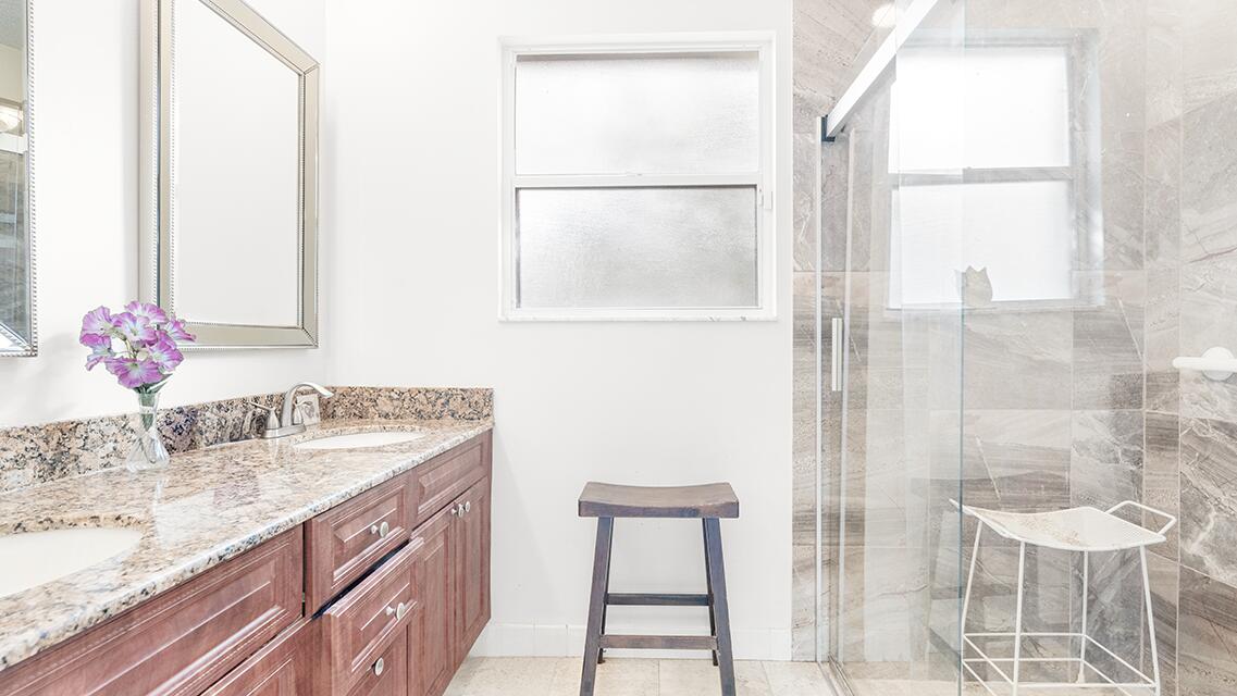 7961 Mansfield Hollow Road Delray Beach, FL 33446 - Photo 10 of 19 a bathroom with a granite countertop sink and a mirror