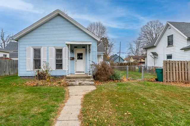 a backyard of a house with table and chairs