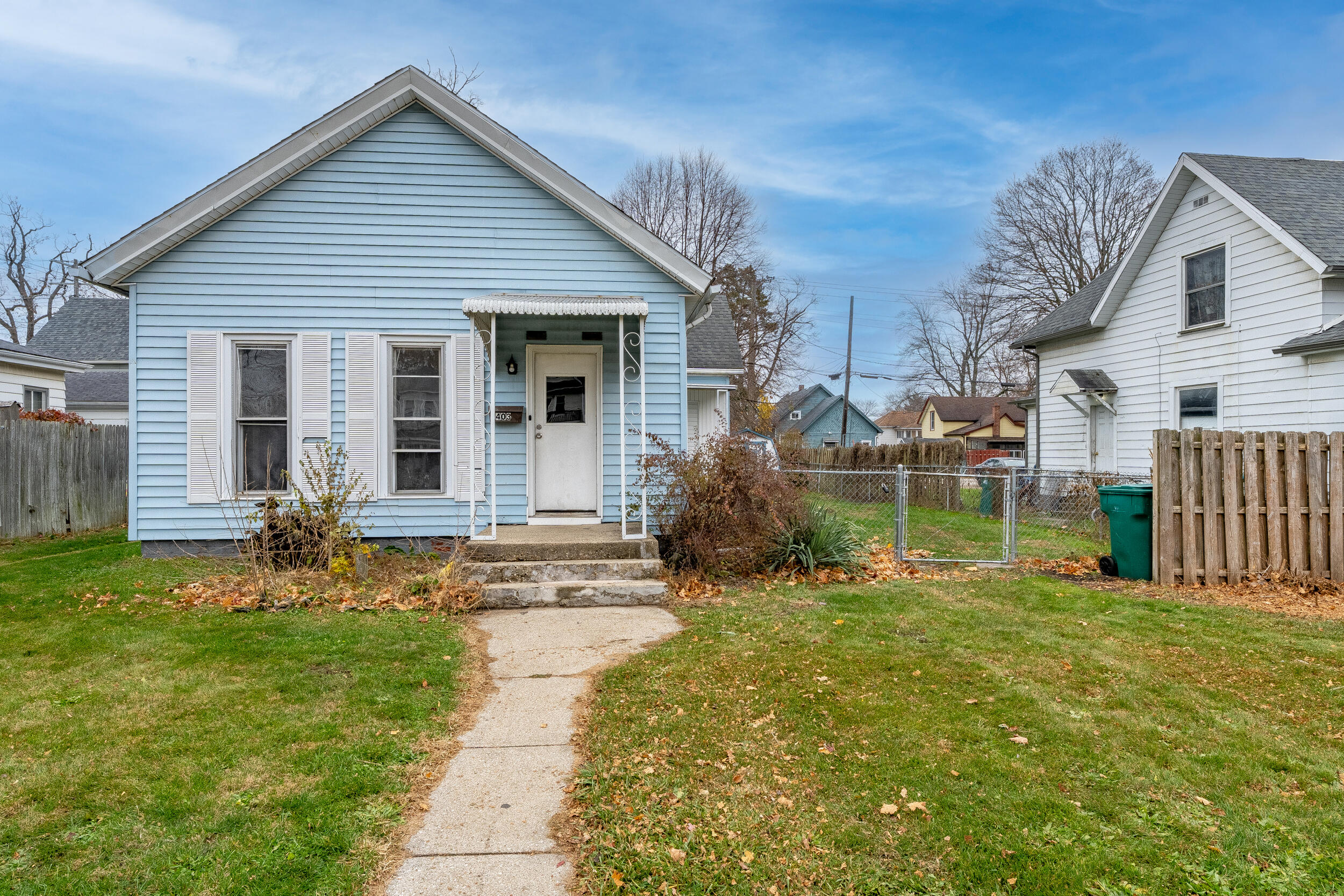 a backyard of a house with table and chairs