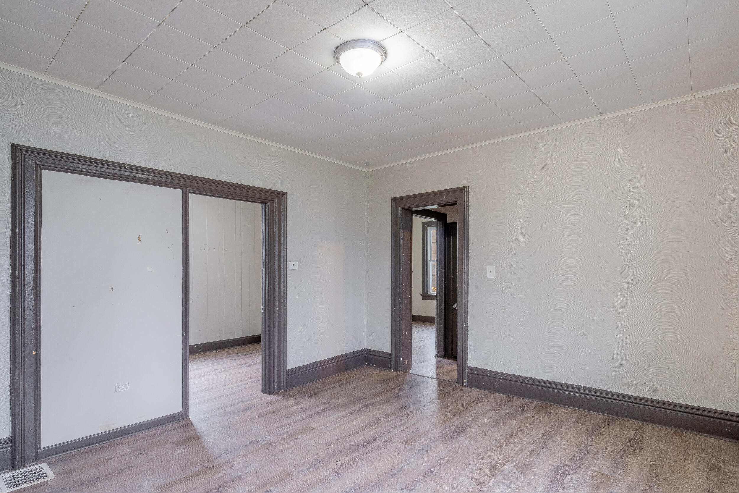 403 Rose Street La Porte, IN 46350 - Photo 11 of 28 an empty room with wooden floor and windows