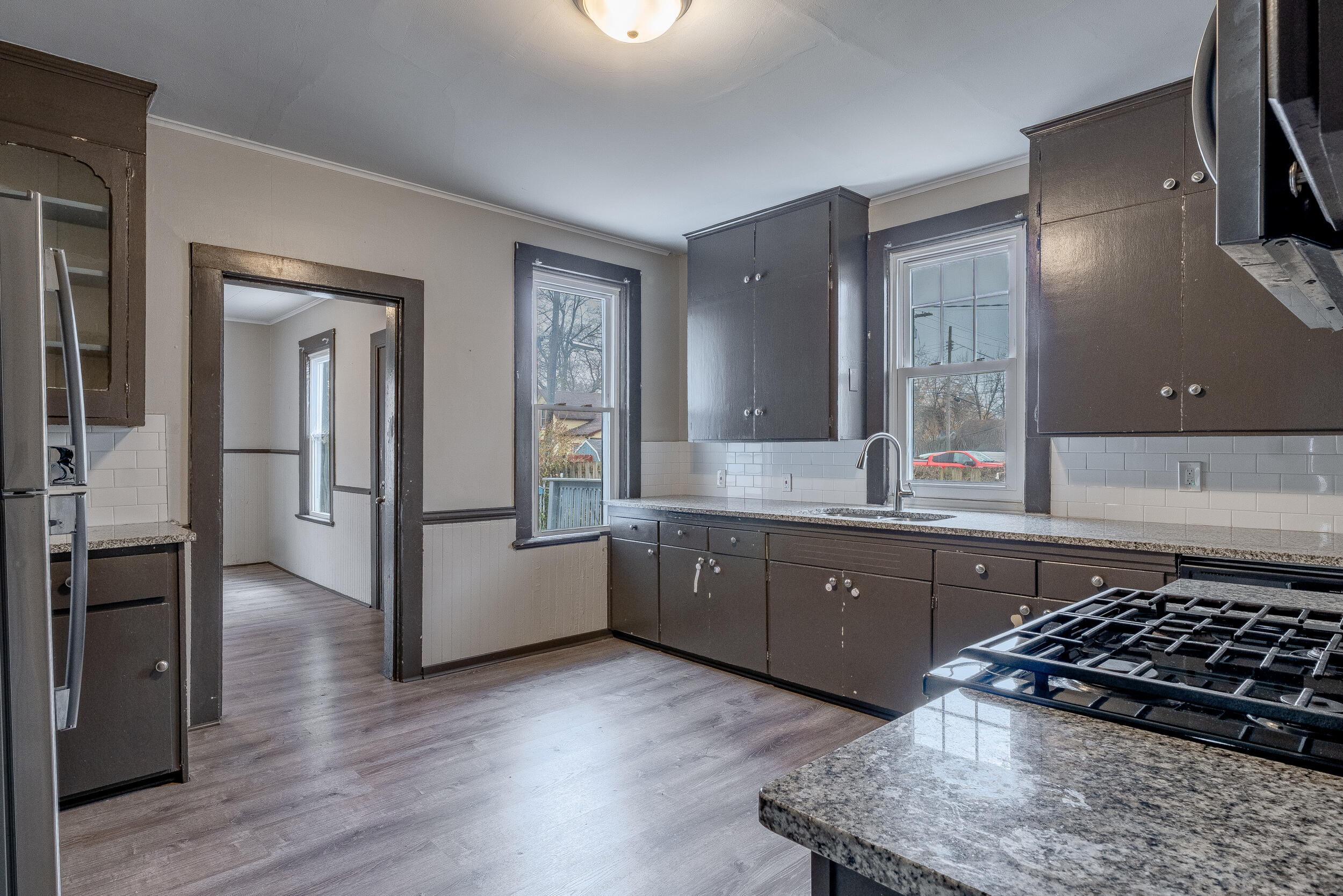 403 Rose Street La Porte, IN 46350 - Photo 12 of 28 a kitchen with stainless steel appliances granite countertop a stove a sink and a refrigerator