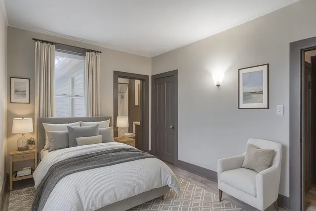 a bedroom with a bed and a couch