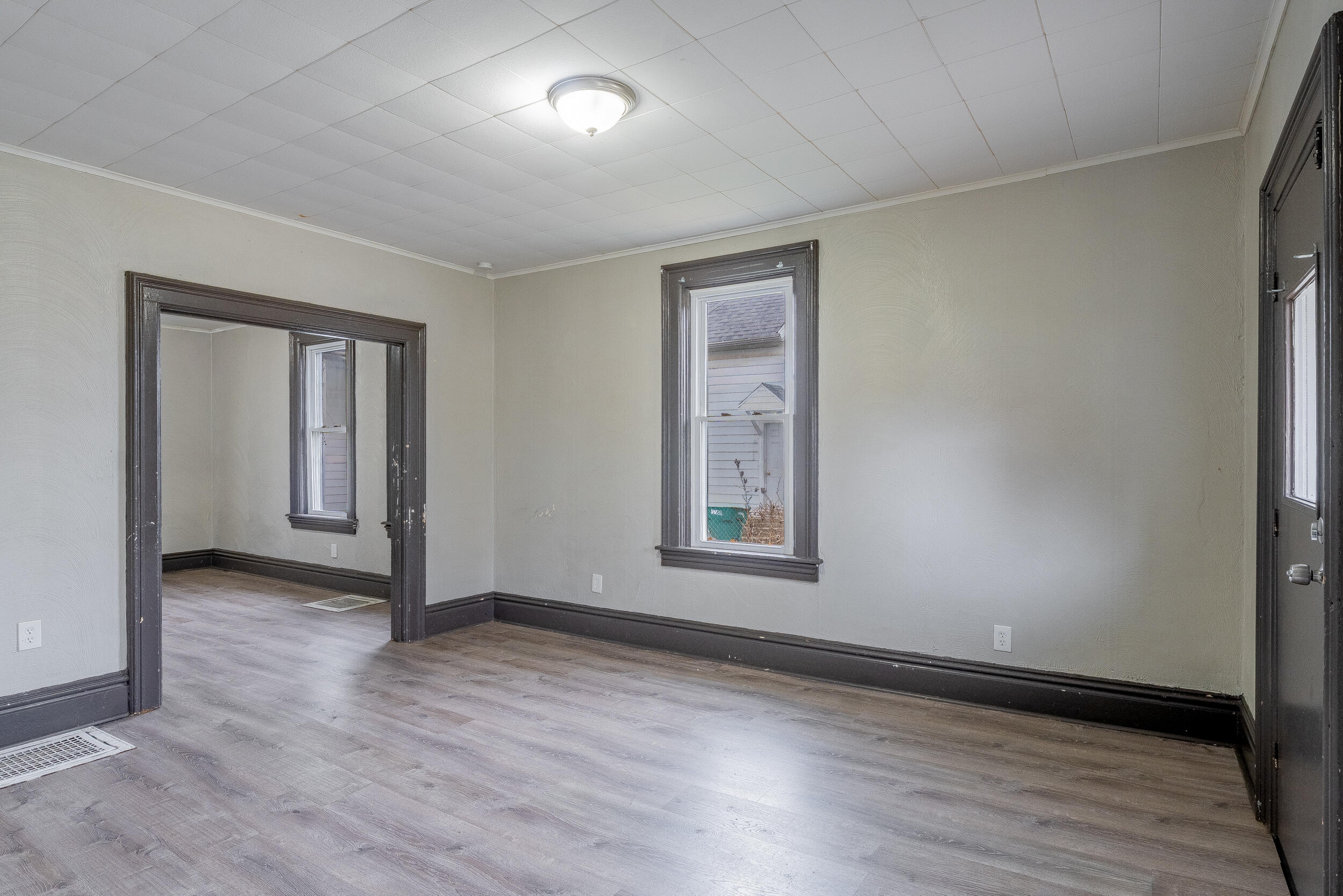 403 Rose Street La Porte, IN 46350 - Photo 5 of 28 an empty room with wooden floor and windows