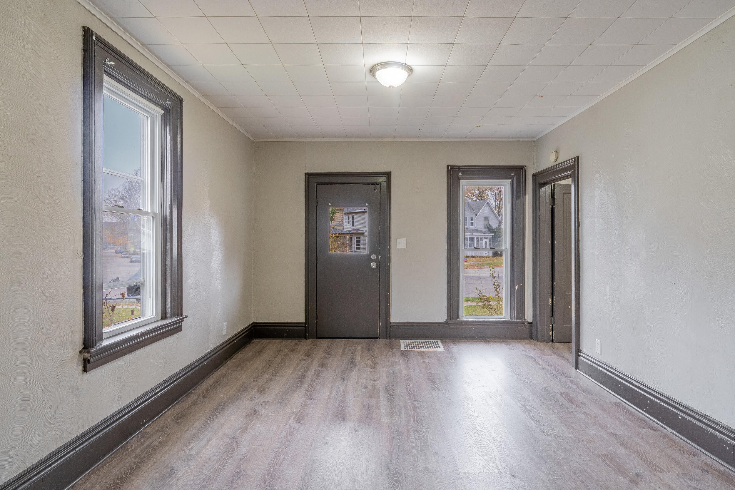 403 Rose Street La Porte, IN 46350 - Photo 7 of 28 an empty room with wooden floor and windows